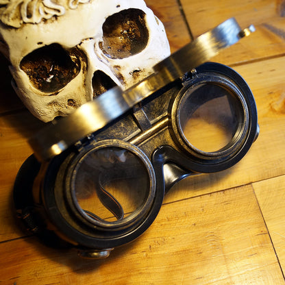A skull with a pair of Retro Industrial Net Lens Goggles by Maramalive™ on top of it.