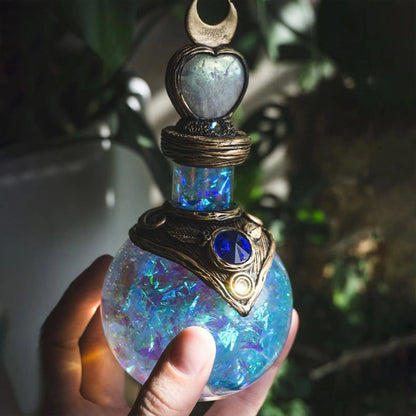 A person holding a Mermaid Moon Bottle perfume bottle by Maramalive™.
