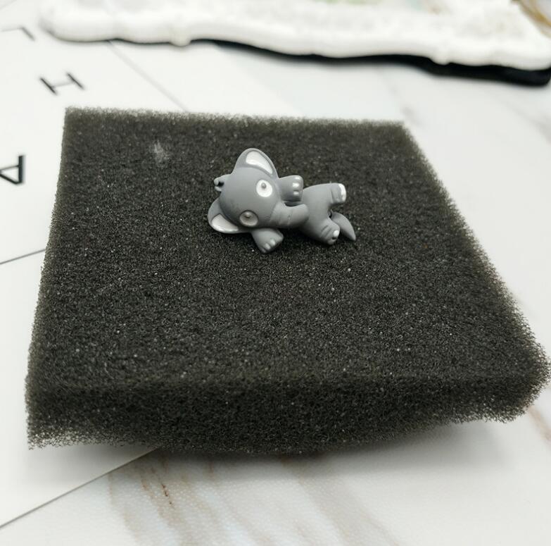 A pair of Maramalive Elephant Earrings sitting on top of a black sponge.