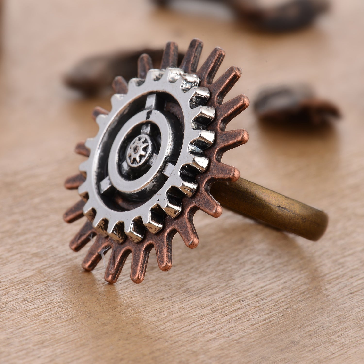 A woman's hand with a Retro Steampunk 3 Ring Gear Ring Jewelry by Maramalive™ on it.