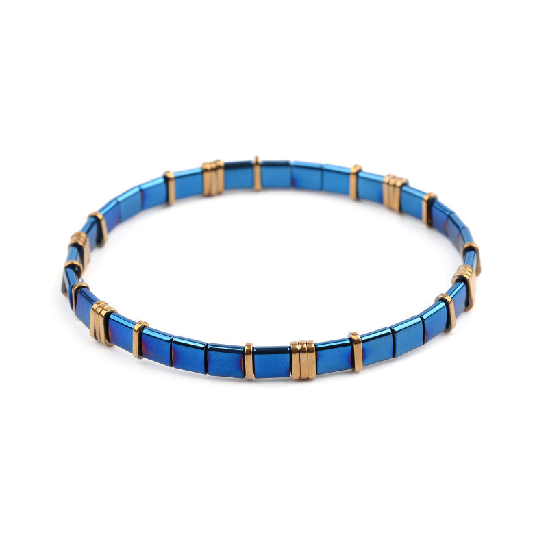 A woman wearing a Maramalive™ Unique and Amazing Square Ceramic Beaded Bracelet in different Colors and Metals with blue and black squares.
