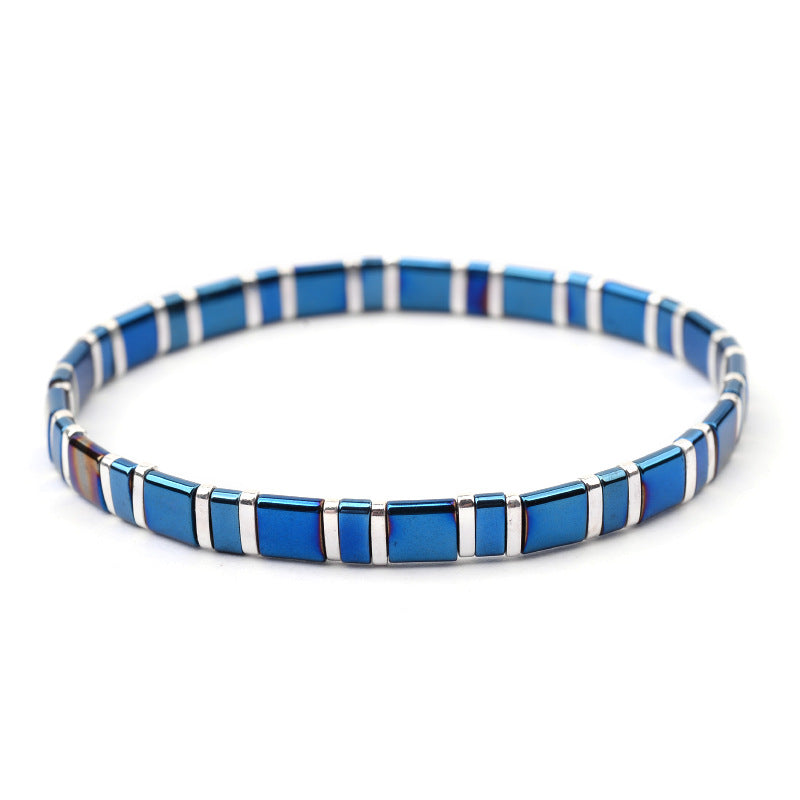 A woman wearing a Maramalive™ Unique and Amazing Square Ceramic Beaded Bracelet in different Colors and Metals with blue and black squares.