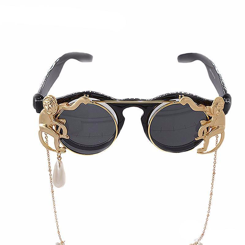 A pair of Maramalive™ Steampunk Vintage Sunglasses with a chain attached to them.