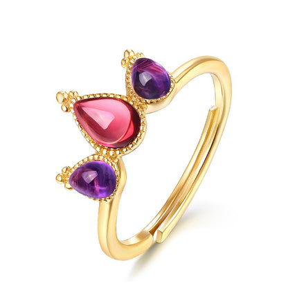 A Maramalive™ gold ring with purple and pink stones.