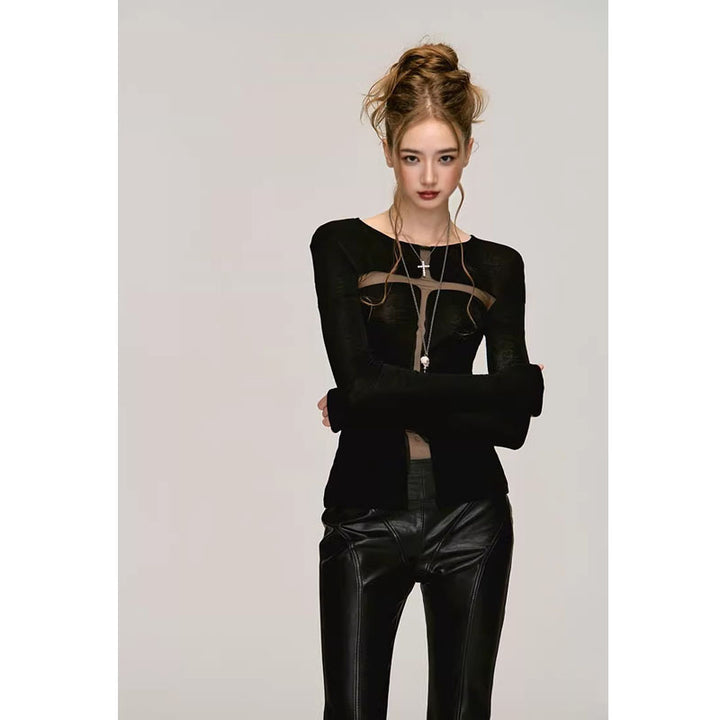 A woman with light skin and blonde hair stands against a plain background, wearing a Maramalive™ Fashion Long Sleeve Bottoming Shirt For Women with sheer panels in polyester fabric and black leather pants. She has a long necklace with a cross pendant, exuding pure desire style.