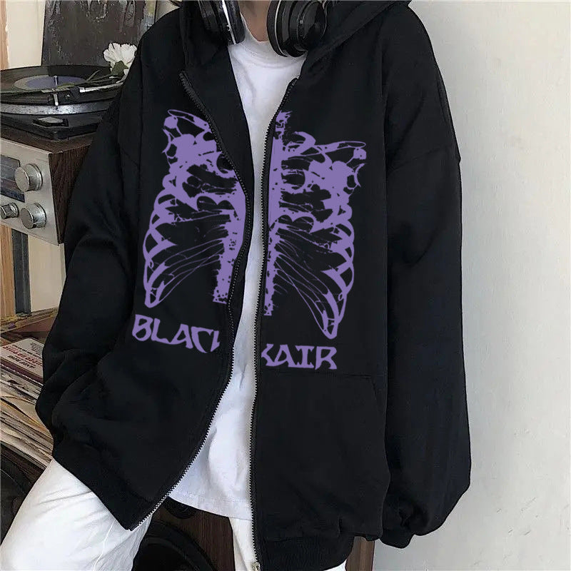 Person wearing a black Maramalive™ Men's Skeleton Zipper Hooded Sweatshirt with a purple ribcage design and the text "BLACK AIR" on the front, standing next to a turntable.