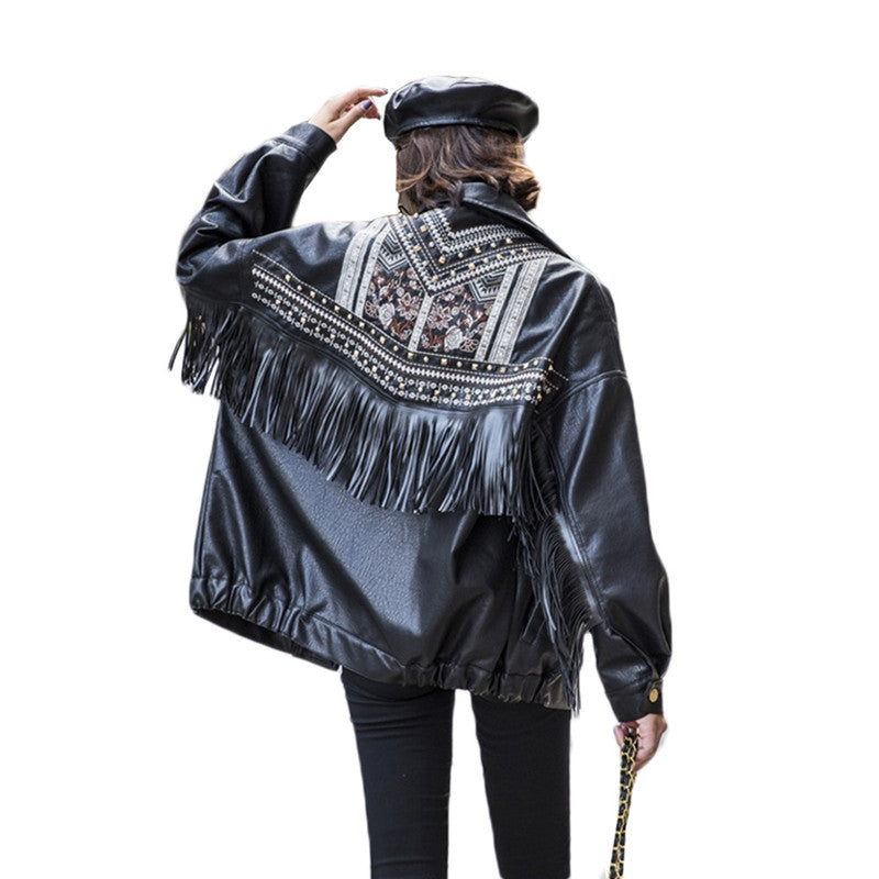 A woman wears a Maramalive™ ladies biker jacket leather- Embroidered, Tassels and Rivets.