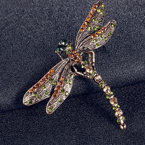 A Vintage dragonfly brooch with green rhinestone and orange stones by Maramalive™.