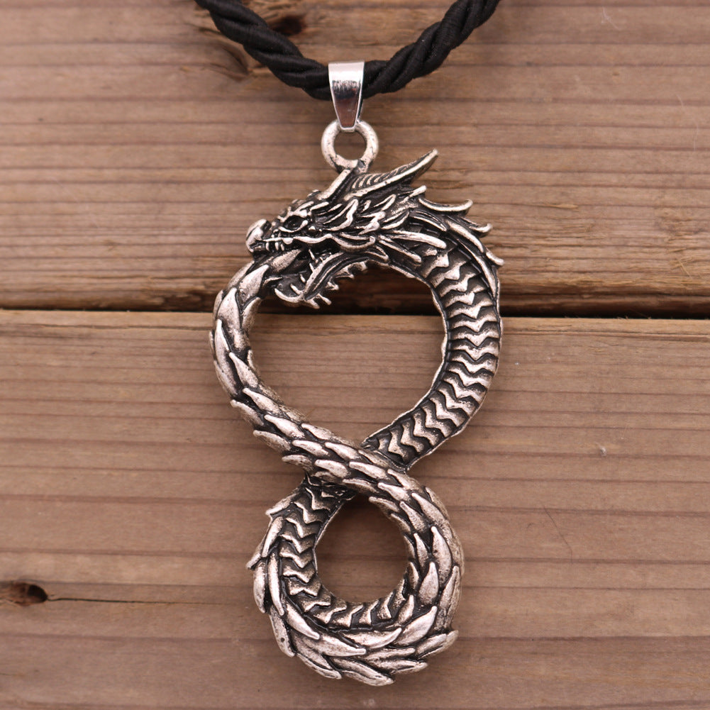 A Dragon Head Pendant on a black leather necklace by Maramalive™.