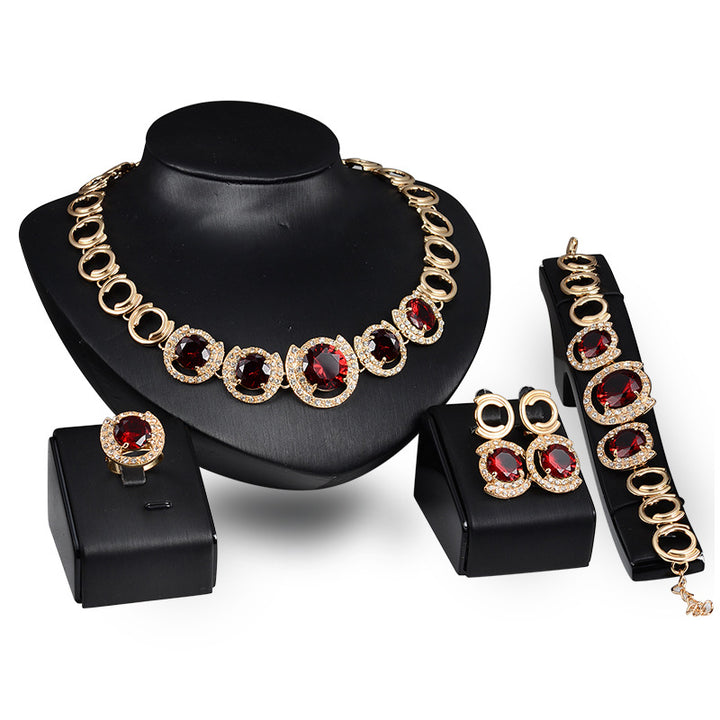 A Maramalive™ gold jewelry set with red stones.