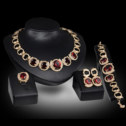 A Maramalive™ gold jewelry set with red stones.