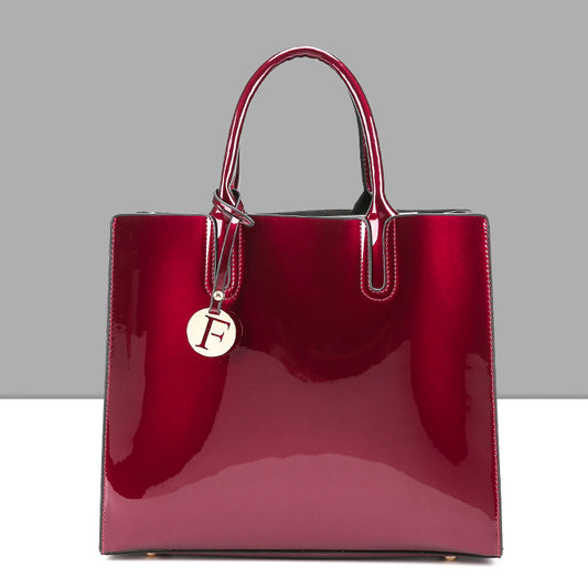 A burgundy patent tote bag with a metal handle, made from high-quality leather was replaced to:
A burgundy Maramalive™ patent shoulder cross-body bag with a metal handle, made from high-quality mirrored leather.