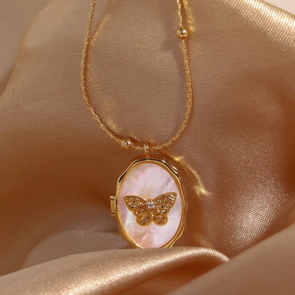 A Butterfly Shell Album Photo Frame Necklace with a pink butterfly on it.