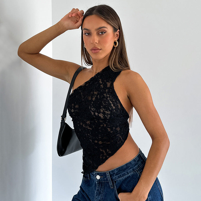 Woman posing indoors, wearing a Maramalive™ Ins Lace Backless Top Summer Solid Color Waistless Asymmetrical Sloped Neck Vest Streetwear Womens Clothes and dark denim jeans, exuding street hipster style while holding a black handbag with one arm resting on her head.
