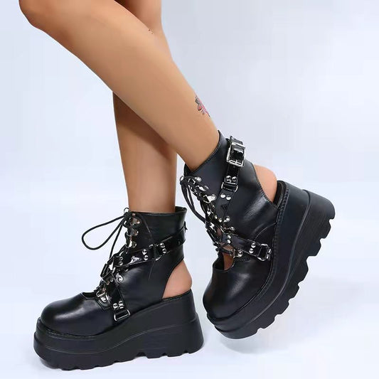 A woman rocking Maramalive™ Gothic Street Punk Plus Size Matte Boots Radical Boot Brigade in black platform boots with chains.