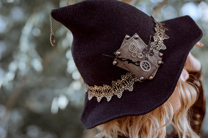 A woman wearing a Women's Steampunk Halloween Witch Hat Black Knitted Wool For Party Masquerade Cosplay Costume by Maramalive™.