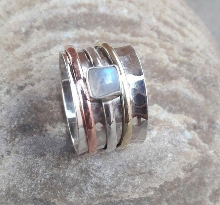 A Heavy Industry Ring Hand Jewelry by Maramalive™, with a blue stone on top.