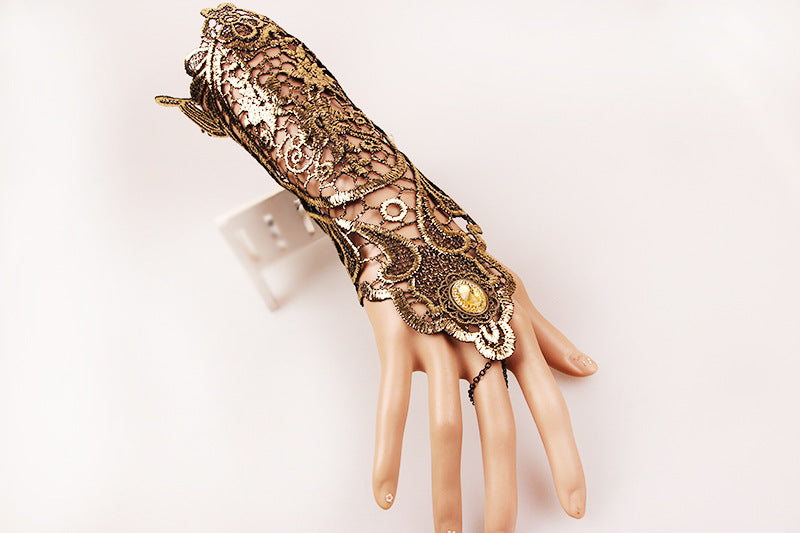 A mannequin's hand with an ornate wrist cuff showcasing Shine On! Vintage Gold Lace Gloves for Refined Retro Style by Maramalive™.