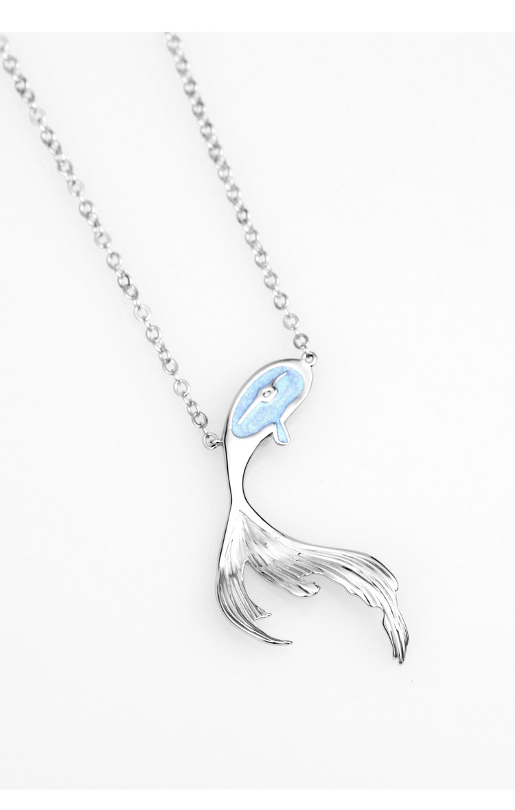 A woman wearing an Original Necklace Mermaid Gift with a fish on it from Maramalive™.