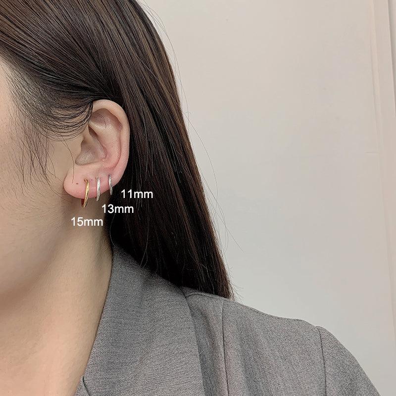 A woman wearing a pair of Maramalive™ Minimalist Spring Geometric Earrings.