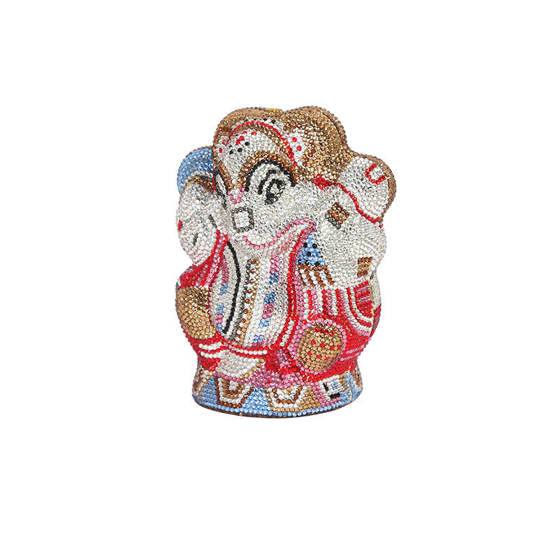 A Women's Handmade Diamond Elephant Shaped Clutch Chain Bag by Maramalive™ sits on top of a stone.