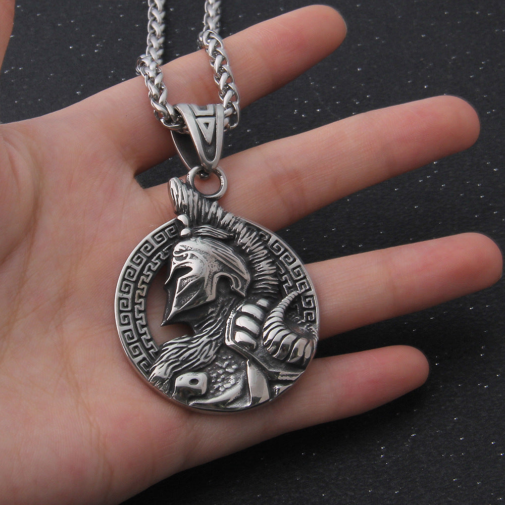 A hand holding a Viking Valor Pendant necklace by Maramalive™.