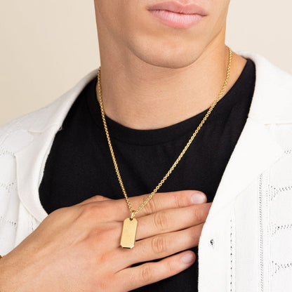 A man wearing a Maramalive™ Trendy Personality Mirror Stainless Steel Geometric Necklace with a tag on it.