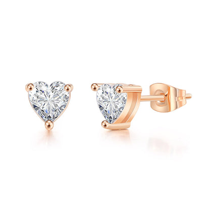 Three Heart Zircon Stud Earrings by Maramalive™ in a person's hand.