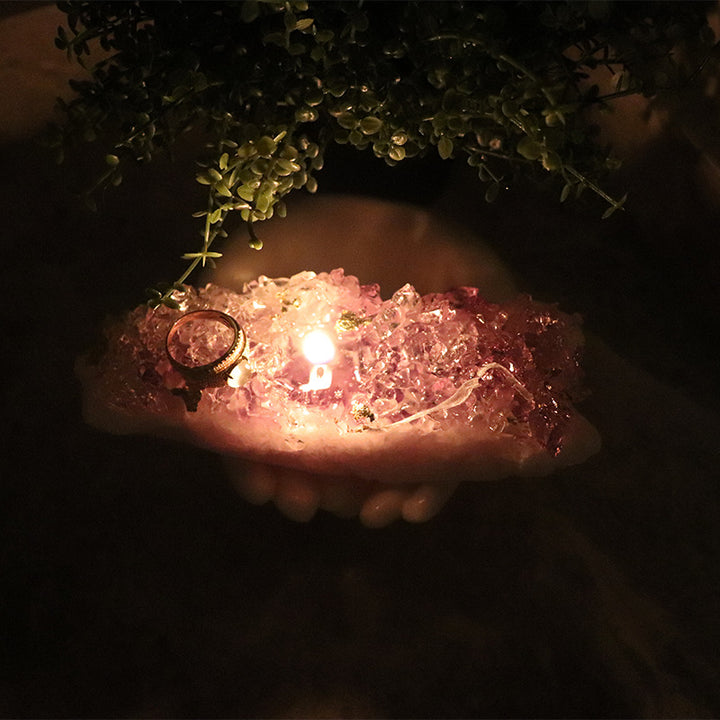 A Maramalive™ Shooting Props Scene Decorating Candle sitting on top of a sheet of music in a fragrant crystal cave.
