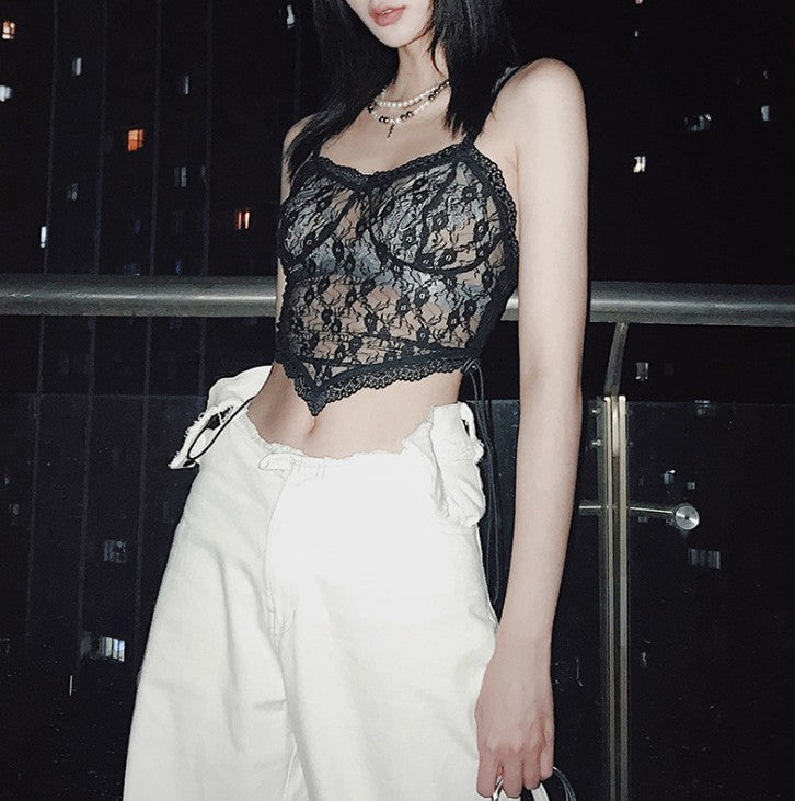 A woman sitting on a bench wearing the Maramalive™ Saucy Sheer Lace Crop Top - Be a Tease in This Flirty Little Number.
