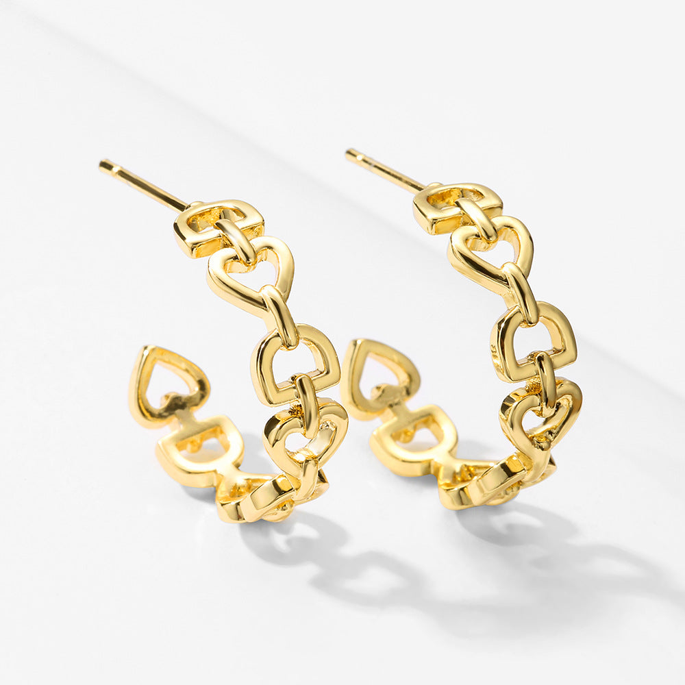 A Minimalist Love Letter Earring set by Maramalive™, plated in gold, on a white surface.