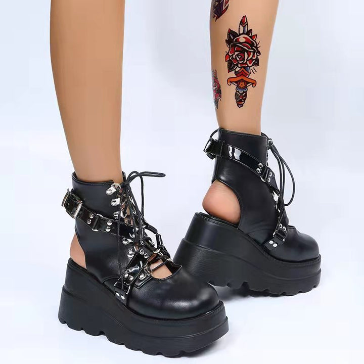 A woman rocking Maramalive™ Gothic Street Punk Plus Size Matte Boots Radical Boot Brigade in black platform boots with chains.