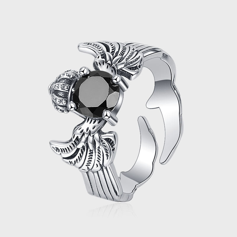 A Maramalive™ Striking Sterling Silver Crown and Wings Ring with a black stone.