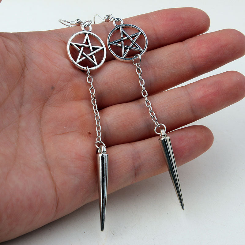 A woman wearing Gothic Pentagram Earrings by Maramalive™.