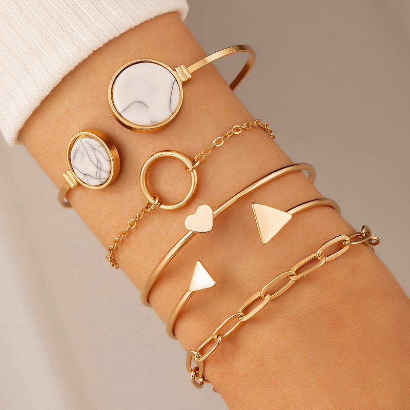A woman's wrist with the Women's Five-piece Bracelet Set With Gemstone Inlaid with C Opening from Maramalive™ on it.