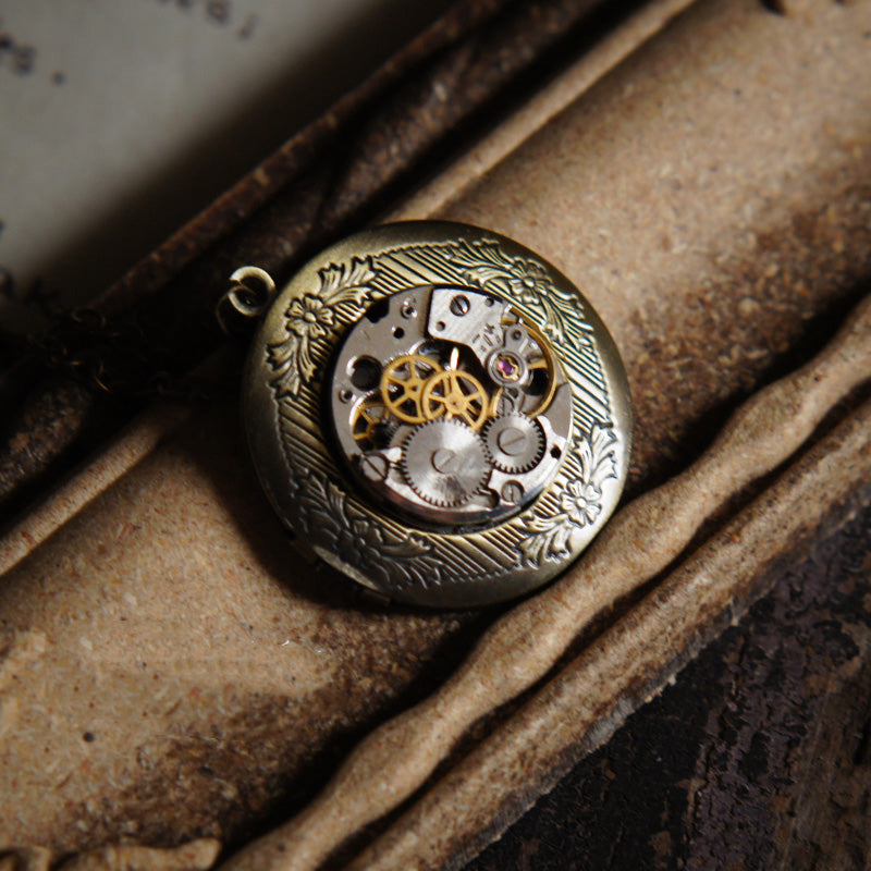 A Bronze Photo Box Necklace Pendant Steampunk with a locket hanging on it made by Maramalive™.