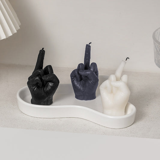 Three black cylindrical Creative And Funny Finger Shaped Fragrant Candles holders on a table. (Brand: Maramalive™)