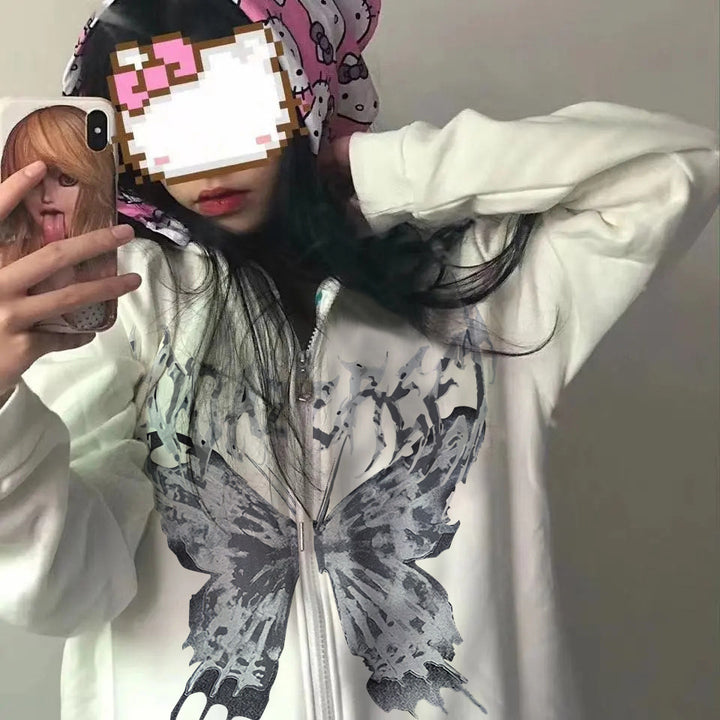 Person with pixelated face taking a selfie in a mirror, wearing the Maramalive™ Comfy Zipper Hoodies for Fall: Hooded Sweatshirts & Sweaters adorned with a large butterfly design on the front and a pink bandana with cartoon prints.