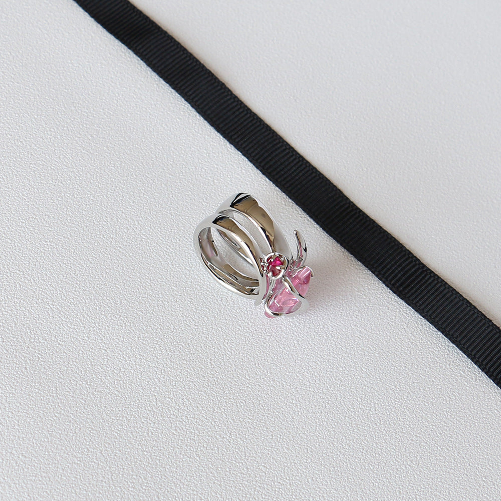 A Zircon Ring Peach Blossom Rose Crystal by Maramalive™ with a pink stone in it.