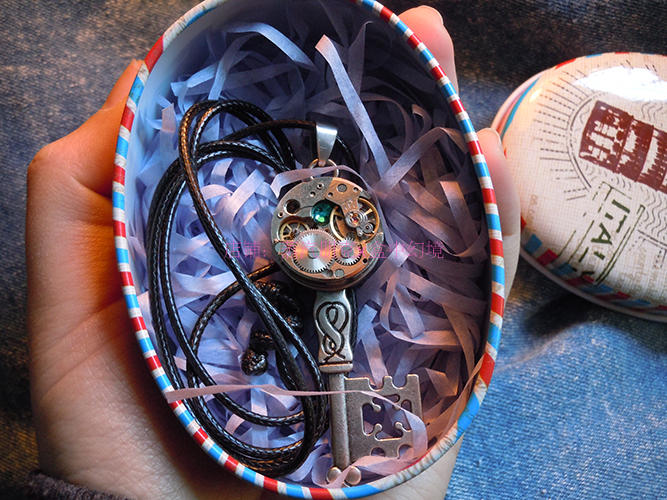 A Silver steampunk vintage handmade necklace by Maramalive™ on a blue denim.