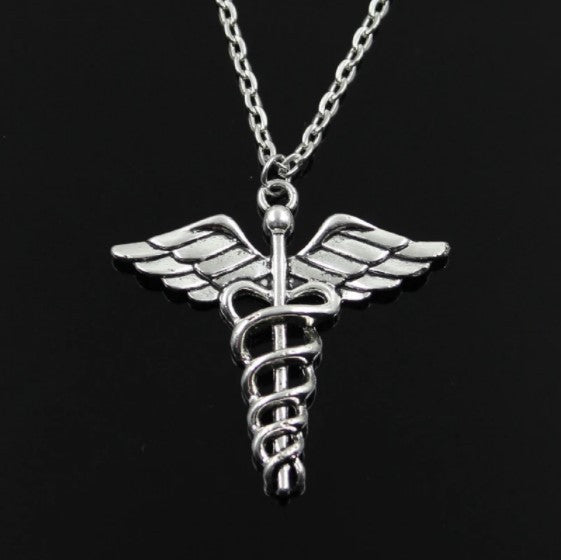 A Maramalive™ Rotating Dragonfly Snake Stick Angel Wings Necklace with a medical symbol in a box.