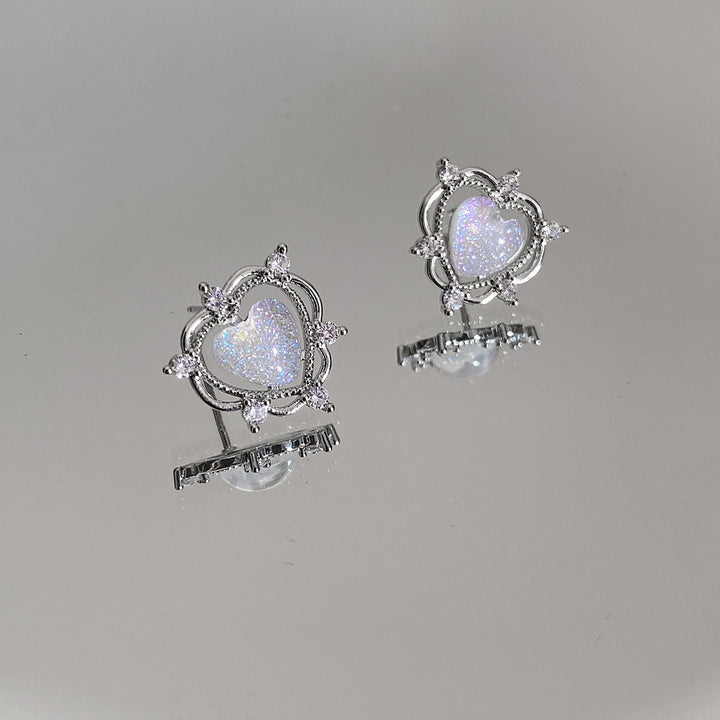 A pair of Sparkling Opal Heart Shape With Diamond Stud Earrings by Maramalive™ on a piece of paper.