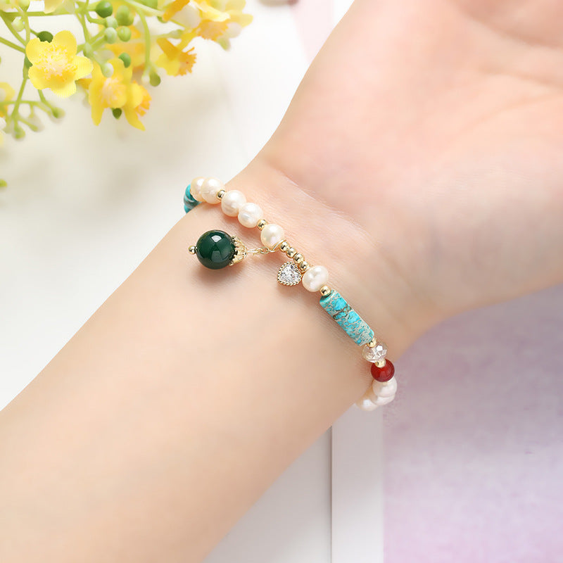 A woman wearing a Maramalive™ Natural Freshwater Pearl Color Matching Agate Turquoise Bracelet.