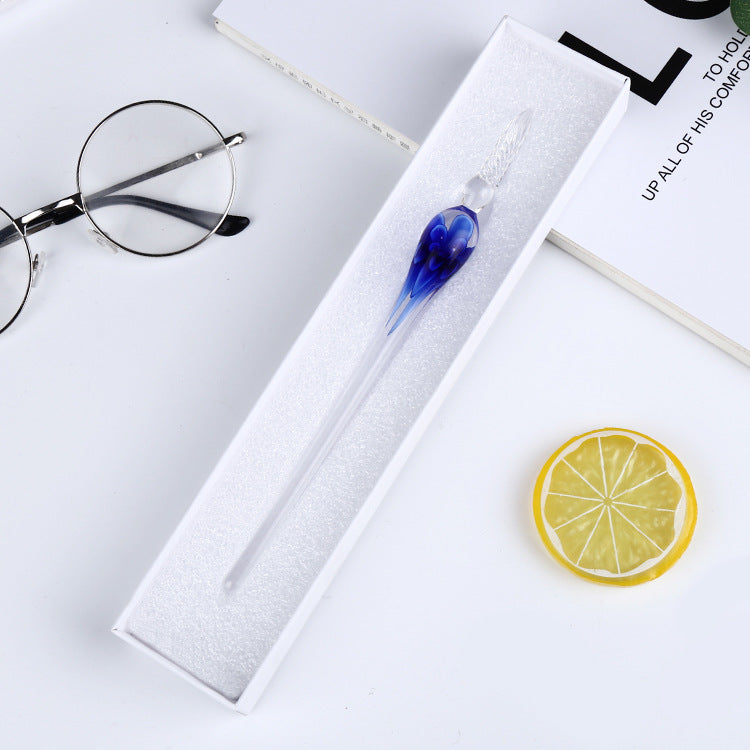 A person holding an Elegant Crystal Flower Glass Dip Pen Set with a flower in it.