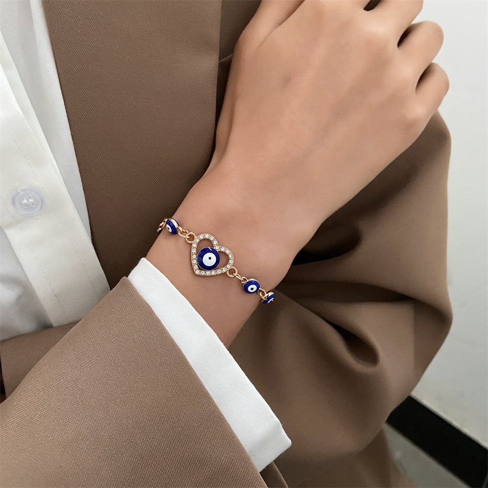 A woman wearing a Minimal Ceramic Beaded Bracelet Adorned with Diamanté Heart by Maramalive™.