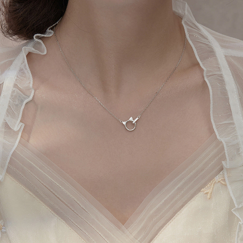 A woman wearing a Cute Kitten Light Luxury Minority Design Diamond Ring Buckle Necklace INS necklace from Maramalive™.
