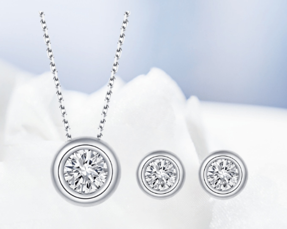 A Round Inlaid Moissanite Jewelry Set Must-have for a Fashionable Woman by Maramalive™, consisting of a silver necklace and earring set with diamonds.