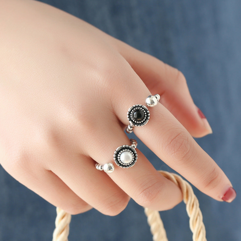 A pair of Maramalive™ Black Onyx Chain Rings on a black background.