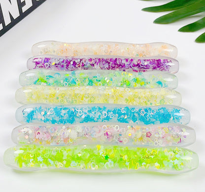 A bunch of Luminous Pen Maramalive™ Dot Drill Pens with glitter on them.