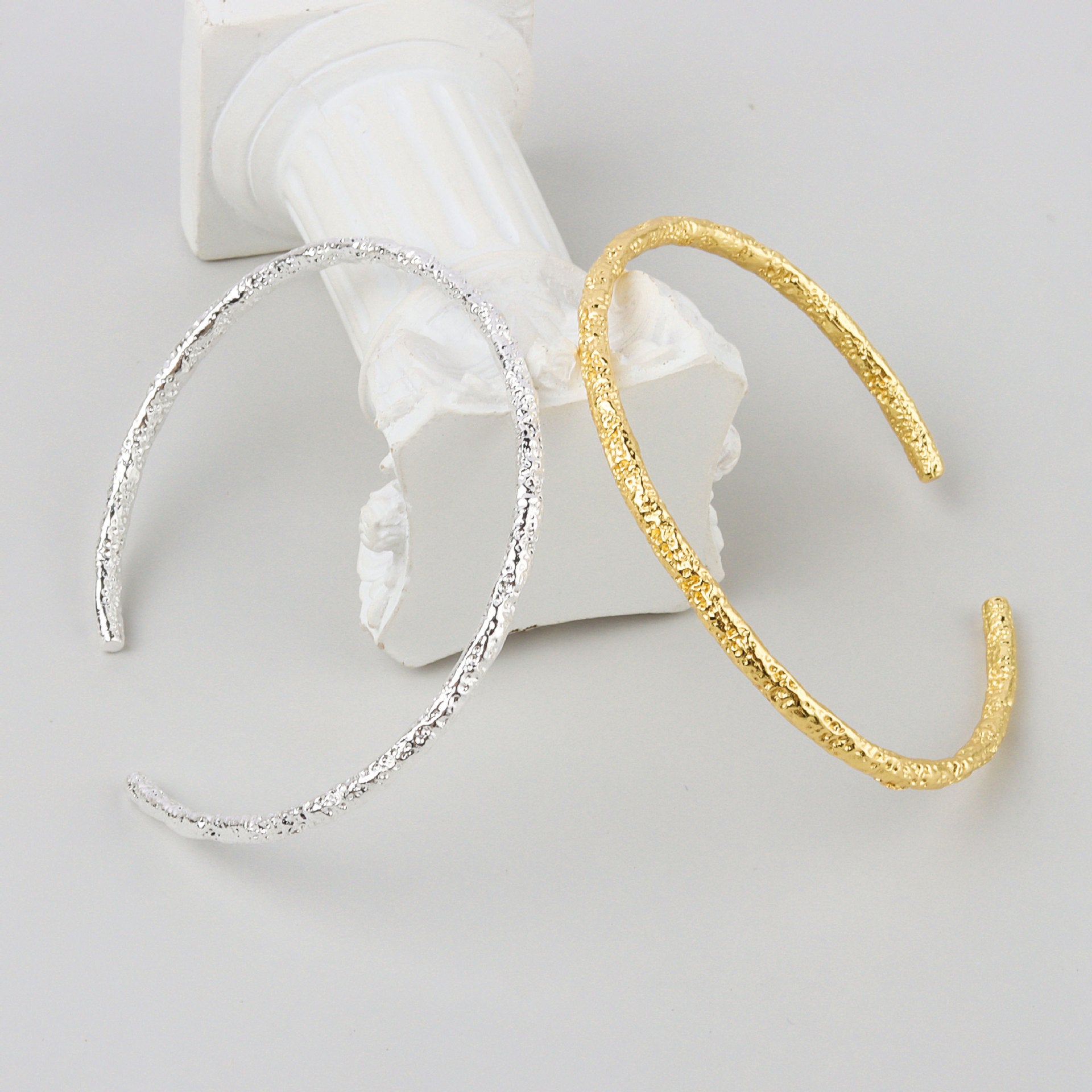 A woman's hand holding a Maramalive™ Women's Fashion Simple And Irregular Bracelet.